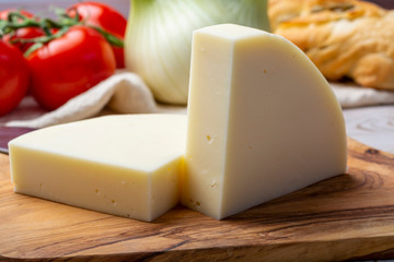 Italian cheese, Provolone dolce cow cheese from Cremona served with olive bread and tomatoes