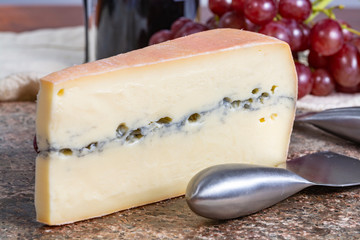 Morbier semi-soft cow milk French cheese with black mold layer