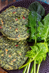 Healthy vegetarian or vegan food, uncooked green spinach burgers, ingredient for hamburgers