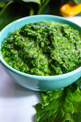 Healthy vegetarian or vegan food, cooked green spinach with cream, ingredient for many dishes like pasta, ravioli or soup