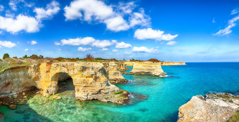 Fototapeta na wymiar Picturesque seascape with cliffs, rocky arch at Torre Sant Andrea