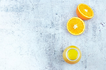 Cold fresh orange juice on a white concrete background. Top view, flat lay, copy space. citrus...