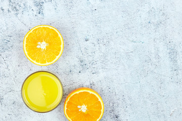 Cold fresh orange juice on a white concrete background. Top view, flat lay, copy space. citrus...