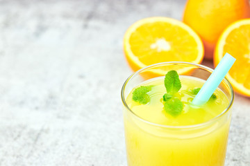Fresh juice Orange juice in a glass with orange slices on light concrete. horizontal view. detox. close-up. copy space. citrus refreshing drink.