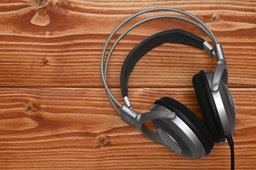 Vintage headphones for listening to sound and music on a wooden background