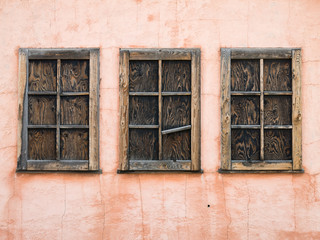 Three boarded up cabin windows at Mormon row in Wyoming