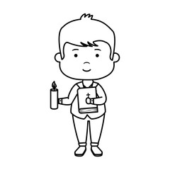 little boy with bible and candle first communion