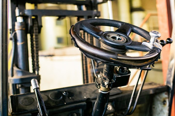 Old Steering wheel Forklift transporting. Enterprise loader