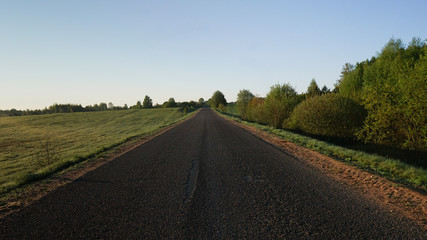 Summer beautiful road, blue sky, sun and trees.Inspirational landscape