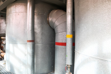 Large iron heat exchanger, tank, reactor, distillation column in thermal insulation of fiberglass...