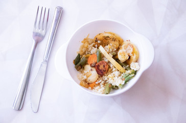 Bulgur and fried vegetables in a plate. Healthy food. Vegetables with porridge in the plate.