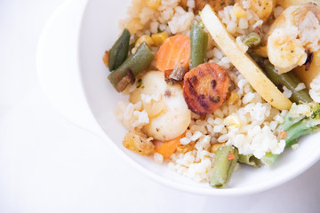 Bulgur and fried vegetables in a plate. Healthy food. Vegetables with porridge in the plate.