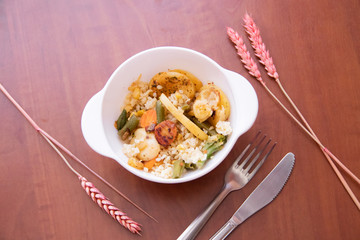 Bulgur and fried vegetables in a plate. Healthy food. Vegetables with porridge in the plate.