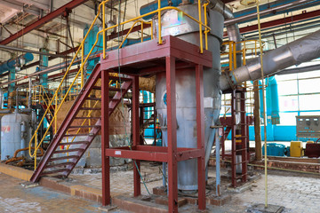 Fototapeta na wymiar Iron metal ladder with safety barriers with steps and railings to raise the heat exchanger equipment at the industrial oil refinery petrochemical plant shop