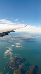 Obraz premium View from airplane window on the wing over Tokyo in Japan. Flying and traveling above the clouds