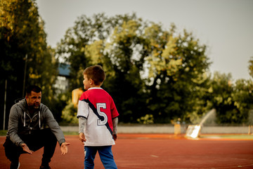 A father and a son are practicing at the court