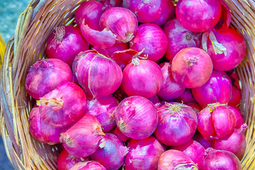 Basket of Fresh Purple Onions on Stand Prepared for Sale.