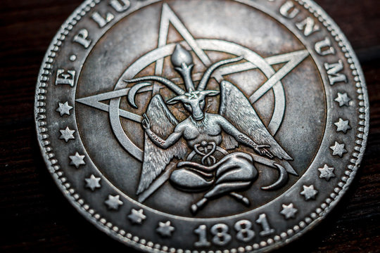 Souvenir coin with the image of a baphomet close-up. Inscription Solve Coagula on Latin