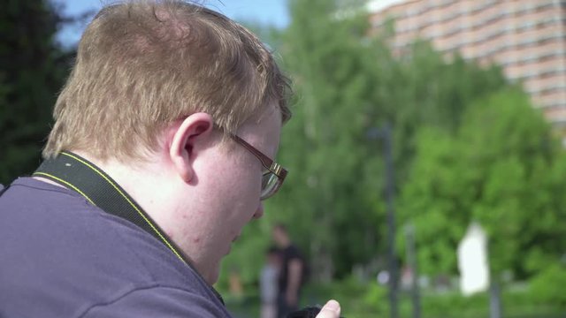 Young man takes pictures in the park