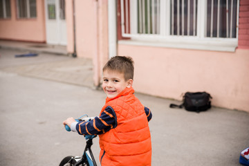 Fototapeta na wymiar A little boy rides a bicycle