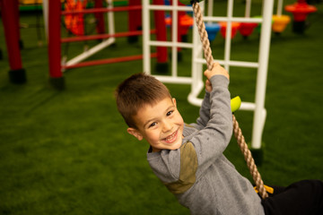 Obraz premium A little boy is playing in the playroom