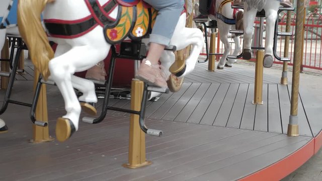 Carousel in a holiday park. Merry-go-round with horses.