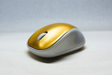 close up of a white and gold computer mouse