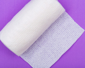 Hospital Grade Sterile Rolled Gauze on purple background.