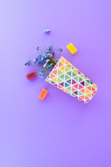 Flowers in a glass on a purple background. Fresh cut purple lilac flowers. colorful dishes, blooming flowers. Copy space