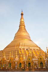 Shwedagon golden pagoda with bright blue sky background in Yangon, Myanmar, Asia