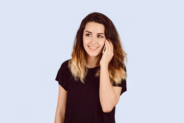 Young woman talking on phone in a studio