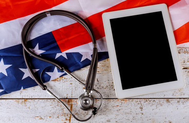 American national flag, stethoscope on US flag on digital tablet