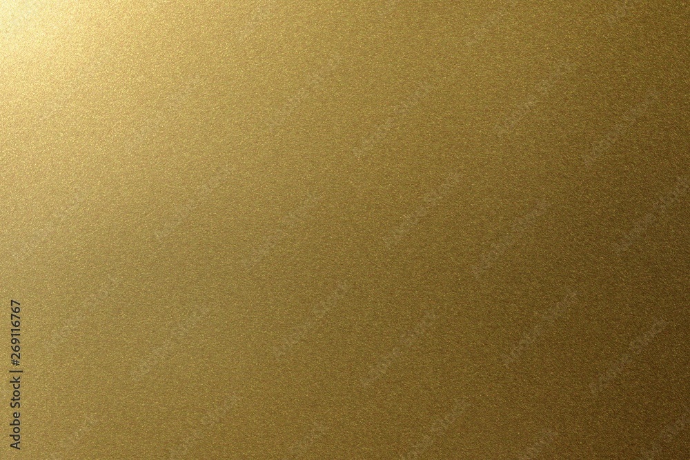 Wall mural Light shining on golden metal plate, abstract texture background