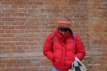 red down jacket on a shy woman