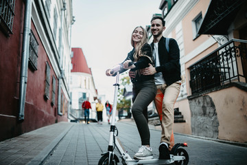 couple in love on the electric scooter in the city