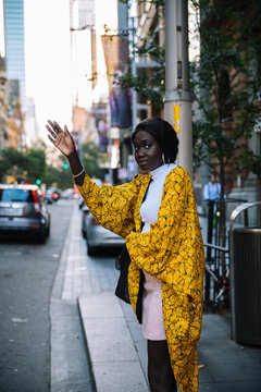 Woman waving for a taxi