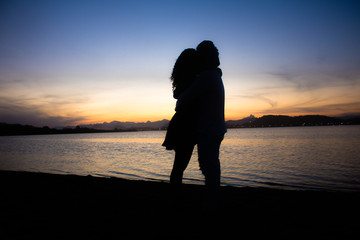 couple huging sunset