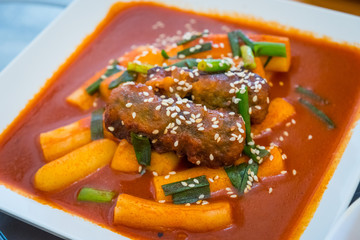 Close up of Tteok-bokki or stir-fried rice cakes is a popular Korean food. It is a traditional food in Korean restaurant.
