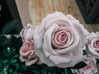 beautiful artificial flowers background, vintage style; Artificial roses