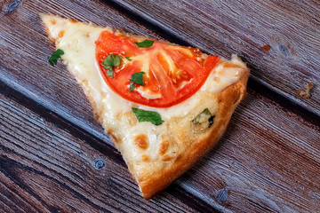 a piece of pizza on a wooden table top view.