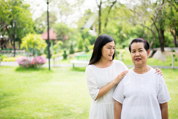 Obraz premium Portrait of a elderly asian women with young women walking at park together,Positive thinking