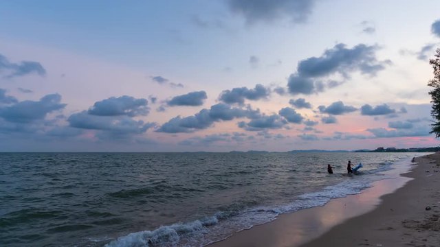 day to night time lapse of Nam Rin Beach with sunset at Rayong, Thailand