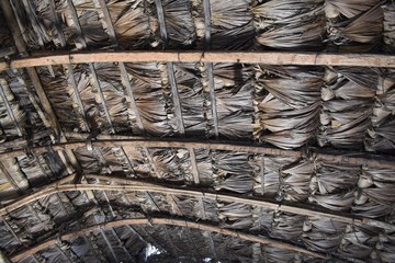 Under a grass thatched roof