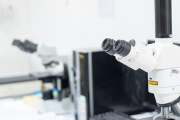 Medical healthcare concept. Ocular eyepiece lenses and tube of binocular microscope for lab technician in laboratory research in hospital or university with white copyspace.Science Education Day