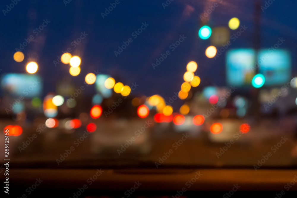 Wall mural defocused city night street view from car front window