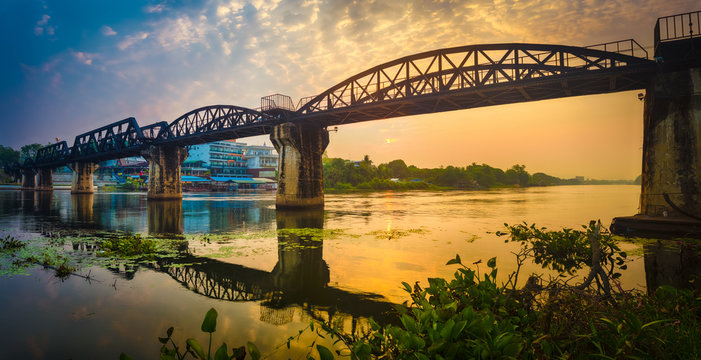 The bridge on the river Kwai at sunrise. Railway in Kanchanaburi, Thailand. Panorama © Olga Khoroshunova