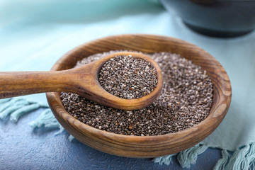 Spoon and bowl with chia seeds on table