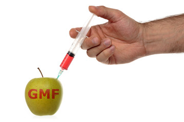 Male hand makes an injection syringe into an apple isolated on white.