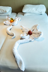 Fototapeta na wymiar vacation decorative close up a animal made of white towel lies on a bed in Egypt nile cruise boat hotel in Africa