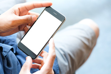 Cropped shot view of man hands holding smart phone with blank copy space screen for your text message or information content, female reading text message on cell telephone during in urban setting.
